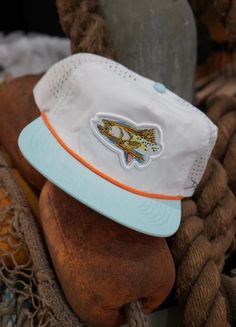 Pre order! Hats should ship in 10 to 14 days roughly! Congrats on being a first batch owner of the brand new limited artist edition hats! COLORWAY: WHITE MATERIAL: NYLON CROWN: MID HEIGHT / SEMI-STRUCTURED PANEL: 5 VENTILATION: PERFORATED HOLE BILL: Flat CLOSURE: SNAP BACK ROPE: ORANGE Affordable Summer Snapback Hat With Curved Bill, Cheap Cotton Hats With Graphic Print, Cheap Curved Bill Snapback Hat For Beach, Cheap Trendy Summer Snapback Hat, Flat Bill Granola Hats, Cheap Fun Snapback Hat For The Beach, Summer Granola Flat Bill Hats, Affordable Trendy Flat Bill Snapback Hat, Leah Fish Hats