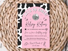 a pink and black birthday party card on a wicker basket with a white polka dot background