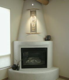 a living room with a fire place in the corner