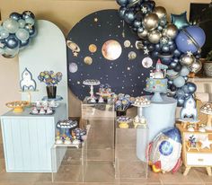 a space themed birthday party with balloons and desserts