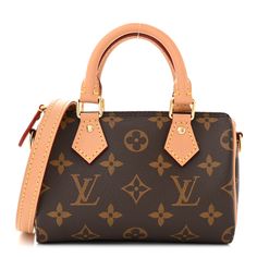 This is an authentic LOUIS VUITTON Monogram Nano Speedy Bandouliere. This bag is crafted of Louis Vuitton monogram on toile canvas. It features vachetta cowhide rolled leather top handles with small polished brass links and an optional vachetta leather crossbody shoulder strap. The top zipper opens to a cocoa fabric interior. Purses And Bags Designer, Crossbody Bag Louis Vuitton, Nano Speedy, Speedy Bandouliere, Designer Shoulder Bag, Girly Bags, Designer Shoulder Bags, Polished Brass, Leather Top