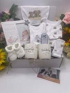 a baby gift box with flowers and other items