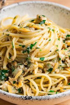 a white bowl filled with pasta and meat