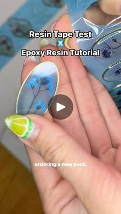 a person is holding some fake flowers in their hand and the text reads resin tape test epoxy resin