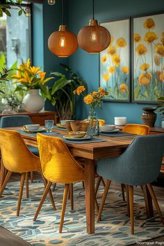 a dining room with blue walls and yellow chairs around a wooden table surrounded by potted plants