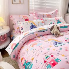 a stuffed animal sitting on top of a pink bed in a child's bedroom