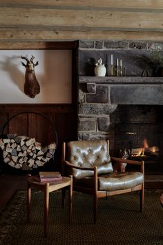 a living room filled with furniture and a fire place in front of a stone fireplace