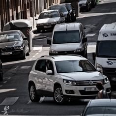 cars are driving down the street in traffic