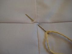 a pair of scissors are cutting through the fabric