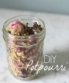 a jar filled with dried flowers on top of a table