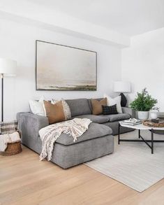 a living room filled with furniture and a painting on the wall