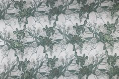 an image of a green and white wallpaper with floral designs on the back ground