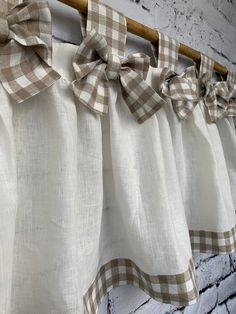 the back of a window curtain with checkered bow ties hanging from it's side