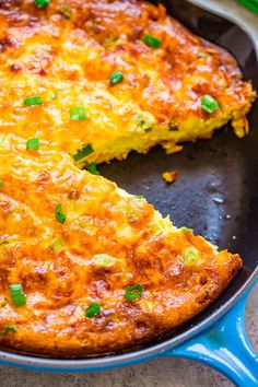 a cheesy pizza is in a pan on the table with a slice missing