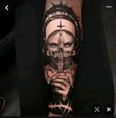 a person with a cross on their arm and a skull in the middle of it