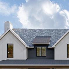 a white house with two garages on the front and one door open to let in lots of light