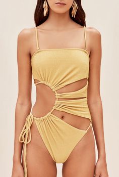 The Allegra one piece features signature Cult Gaia cutouts in a sunburst form. An adjustable tie at the right hip allows for secure fit. Shoulder straps are removable for customized wear. 10% of her fabric is composed of metallic paillettes to give some refined shine. She is slightly textured, which provides an effect of extra coverage. A gold-toned, brushed brass Cult Gaia logo can be found at the center back. 얼굴 그리기, Cut Out One Piece, Creation Couture, Cult Gaia, Cute Swimsuits, Womens Bathing Suits, Outfit Inspirationen, Womens Swimwear, One Piece Swimsuit