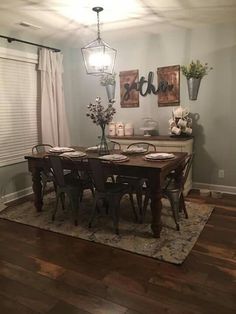 the dining room table is set with place settings