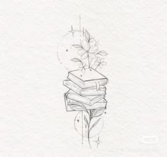 a stack of books sitting on top of each other in front of a flower vase