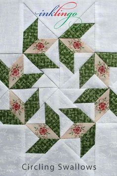 the block is made up of green and white quilts with red flowers on them