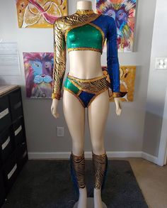 a female mannequin dressed in an egyptian inspired outfit with gold and blue accents