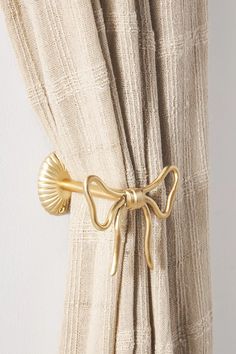 a curtain with a gold bow tie on it