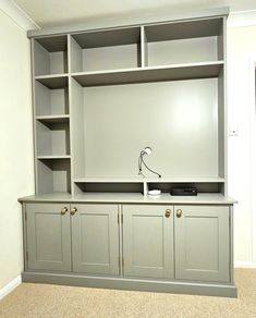 an empty entertainment center with built in bookshelves and cupboards on the wall