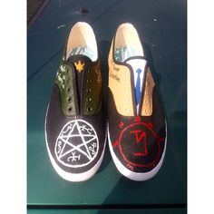 two pairs of shoes painted with symbols on them