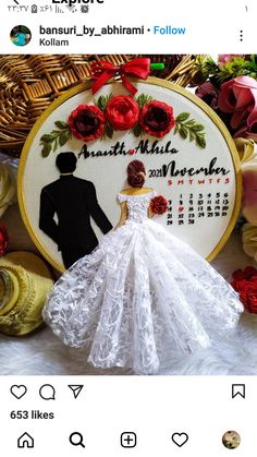 the bride and groom are posed in front of their wedding day date embroideryed on fabric