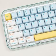 a white and blue keyboard with yellow keys