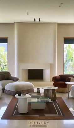 a living room filled with furniture and a fire place in the middle of it's wall