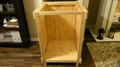 a wooden cabinet sitting on top of a hard wood floor