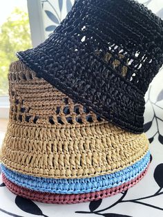 The raffia crochet bucket hat is the epitome of a versatile summer accessory. With its lightweight and breathable design, it effortlessly transitions from a chic sun hat for lounging by the beach to a practical straw gardening hat for tending to your plants with style. Its intricate crochet pattern adds a touch of bohemian charm, making it a fashionable choice for any summer outing. Either you're strolling through the farmer's market or enjoying a picnic in the park, this knit bucket hat provides both sun protection and a laid-back, slouchy vibe, ensuring you stay cool and stylish all season long. Color: multiple One size Materials: raffia Processing time: Up to 5 business days Delivery time: 7-14 business days Personalization: I can create a product according to your wishes, in the desire Straw Crochet Hat For Warm Weather, Summer Bucket Hats For Beach Season, Casual Straw Bucket Sun Hat, Spring Straw Bucket Hat, Black Straw Bucket Hat For Vacation, Summer Woven Bucket Hat With Short Brim, Woven Summer Bucket Hat, Vacation Crochet Hat With Curved Brim, Adjustable Bucket Straw Hat For Beach