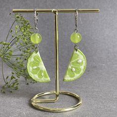 Welcome to our delightful collection of Lime Earrings! If you're a fan of all things citrusy and fun, then these lime-themed earrings are the perfect addition to your jewelry collection. Each pair is meticulously handcrafted with love and care using high-quality materials, ensuring you'll have a piece of wearable art that will brighten up your day. These handmade earrings are designed to bring joy! Earrings length 6,5 сm (2.5 inches). The earrings are suspended on zirconium links and rhodium plated Our Lime Slice Earrings are a real show-stopper. These eye-catching dangle earrings  a realistic slice of lime made from polymer clay. The vibrant green hue of the lime slice exudes a fresh and zesty vibe that is sure to draw attention and compliments wherever you go. The attention to detail is Cheap Lime Green Earrings For Gift, Coconut Earrings, Coconut Jewelry, Funky Fruit, Summer Pendant, Lime Slice, Mod Earrings, Funny Jewelry, Fruit Necklace