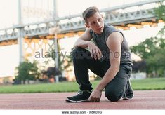 a young man sitting on the ground