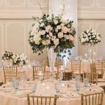 the tables are set with white flowers and candles