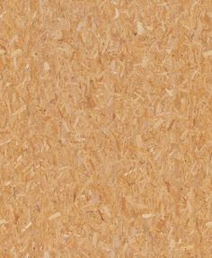 a close up view of a cork board textured with wood shavings and nails