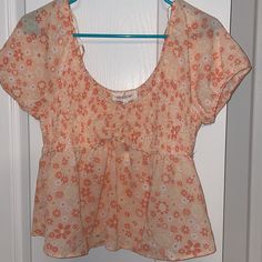 Coral Colored Cropped Peplum Top. Breathable Material. Size L. Never Worn. Tags Attached. Fitted Floral Print Peach Tops, Fitted Peach Floral Print Tops, Peach Floral Print Summer Blouse, Cute Apricot Tops For Spring, Cute Apricot Top For Spring, Pink Rose Print Blouse For Summer, Faux Turtleneck, Peasant Crop Top, Peplum Crop Top