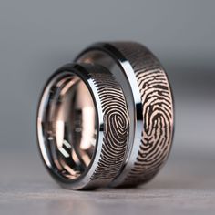 two wedding bands with fingerprints on them