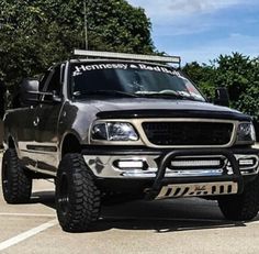 a black truck parked in a parking lot