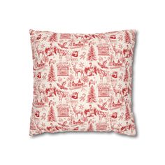 a red and white christmas pillow on a white background with an image of trees, deers, snowflakes