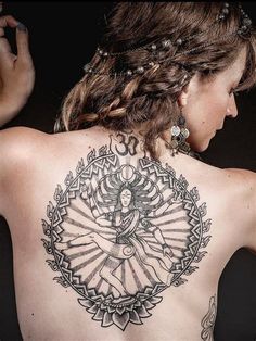 a woman with a tattoo on her back