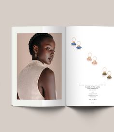 an open book showing the inside pages of a fashion magazine, with earrings on it