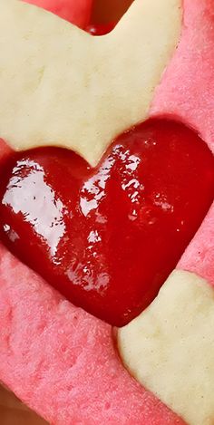 a heart shaped piece of fruit with some ketchup on it