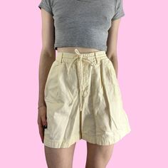 Vintage 90s Eddie Bauer Pastel Yellow High Waist Shorts Drawstring/zipper/button closure with a stretchy waist and pockets. Brand - Eddie Bauer Tag size - 4 Seen on size small, 5'4 with waist pinned Measurements (laying flat) Waist (no pull) 11 in - (taut) 13.5 in Hips (3 inches above crotch seam) - 21 in Rise - 11.5 in Inseam - 5.5 in  Leg opening - 12.5 in Recommend for a size small depending on desired fit #outdoor #yellowshorts #granolagirl #eddiebauershorts #highwaistshorts Retro Shorts With Pockets For Spring, Fitted 90s Inspired Bottoms With Pockets, Vintage Bottoms With Side Pockets For Spring, 90s Style Shorts With Pockets, 90s High-waisted Cotton Shorts, 90s Style High-waisted Cotton Shorts, Vintage Bottoms With Side Pockets, Short Length, 90s Style Short Bottoms With Pockets, 90s Style Bottoms With Built-in Shorts For Spring