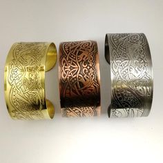 This dragon cuff is a new design for 2019 and has been designed with both Celtic and Norse viking styles in mind. The original design is conceived completely hand drawn by myself before being digitised and readied to create these magnificent etched pieces. Perfect statement art jewellery for all dragon lovers. Available in Copper, Brass and Stainless Steel.Copyright remains with Anna McDade.Width: 3cm / 1.2 inchesMetal gauge: 1mmSizings: Small: 14cm (approx 5.5 inches) metal length plus up to 2. Viking Style Metal Bracelet For Gift, Medieval Handmade Cuff Bracelet As A Gift, Medieval Adjustable Bangle Cuff Bracelet, Handmade Medieval Cuff Bracelet As Gift, Handmade Medieval Cuff Bracelet For Gifting, Adjustable Medieval Bangle Cuff Bracelet, Bronze Cuff Bracelet With Intricate Design For Gift, Bronze Metal Cuff Bracelet For Festival, Norse Dragon