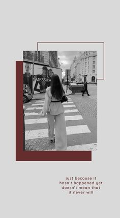 a woman walking across a cross walk in front of a building with the words just because it doesn't happened yet, it never will