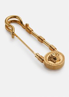 A cemented symbol of the brand, this Safety Pin brooch features a three-dimensional La Medusa at the centre. All Versace jewelry  products are lead and nickel free. All materials are hypoallergenic. Versace Safety Pin, Safety Pin Jewelry, Womens Safety, Safety Pin Brooch, Versace Jewelry, Gold Brooches, Pin Jewelry, Gianni Versace, Goods And Services