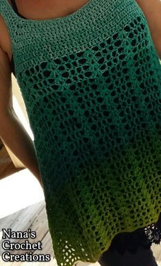 a woman is wearing a green crochet top