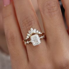 a woman's hand with a diamond ring on top of her finger and an engagement band